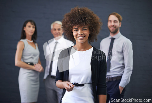 Image of Portrait, team leader and happy business woman in studio isolated on a blue background. Face, smile and group of diverse professional consultants in collaboration, cooperation and working together