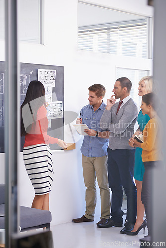 Image of Creative coach, chalkboard and presentation with team for storyboard, development or meeting at office. Speaker talking to group of employees for project planning, production or startup at workplace