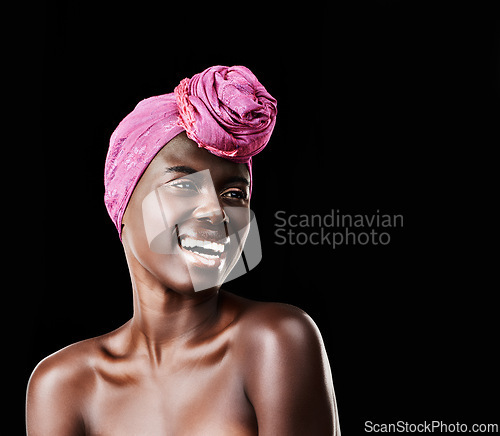 Image of Black woman, head wrap and laugh with natural beauty, skincare and cosmetics in studio. Traditional, turban and African style with wellness and skin glow in makeup with confidence and dark background