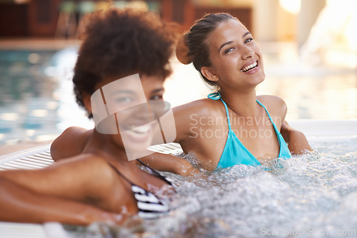 Image of Women, friends and portrait in jacuzzi at spa, self care and relax on pamper day for wellness and healing. Water, bubbles and happy hot tub for detox and stress relief, friendship date and bonding