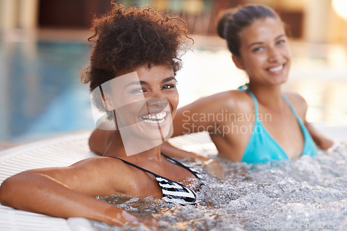 Image of Women, friends and happy in portrait in jacuzzi to relax, self care and pamper day at spa for wellness and healing. Water, bubbles and hot tub for detox and stress relief, friendship date and bonding