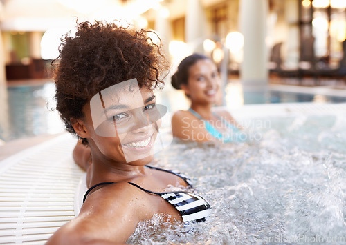 Image of Happy woman, portrait and relax with water in jacuzzi at hotel, resort or hot tub spa together. Face of female person or friends with smile for relaxation, hospitality or heated bath by indoor pool