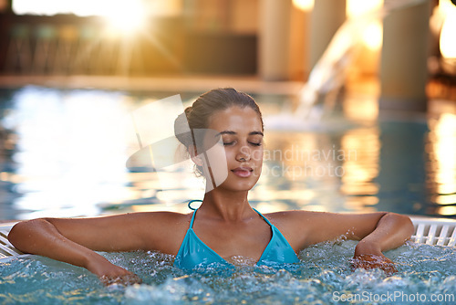 Image of Woman, face or relax in jacuzzi at resort for luxury vacation, summer holiday or spa on weekend. Tourist, girl and confidence with rest in swimming pool for sun tan, fun getaway or wellness in bikini