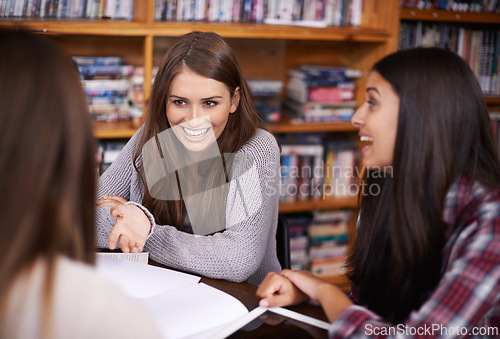 Image of Women, students and laughing for funny joke in library and news or campus gossip in university. Friends, talk and silly humor on break in bookshop or comedy discussion for bonding together at college