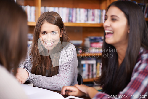 Image of Women, university and laughing for funny joke in library and news or student or campus gossip. Friends, talk and silly humor on break in meeting or comedy discussion for bonding together at college