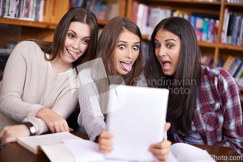 Image of Women, students or tablet selfie on university campus or bonding together for crazy update on social media. Learners, touchscreen or post online as goofy friends or solidarity with care in library