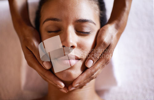 Image of Woman, relax and face massage at spa with hands and care for facial, wellness and beauty treatment on bed. Above, towel and calm african female woman with skincare and rest at hotel with skin glow