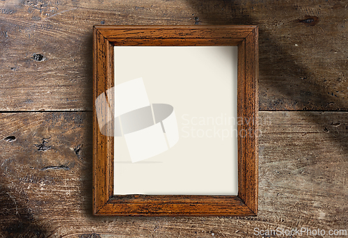 Image of empty wooden frame on wall