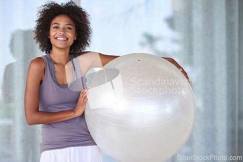 Image of Woman, portrait and happy with exercise ball for fitness, wellness and health at home or window. Excited and young African person with workout, pilates and balance equipment for practice and training