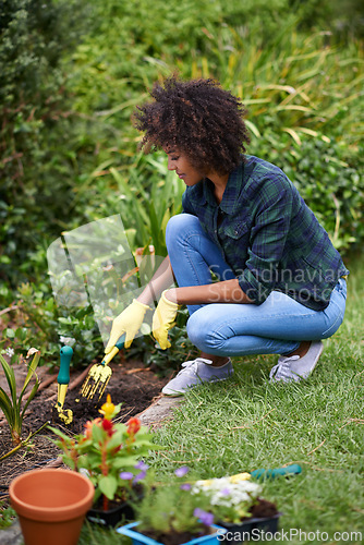 Image of Woman, gardening and fork for soil, plants and happy for spring, outdoor and sustainability. Girl, African person and smile on ground for growth, development and nature with ecology in backyard