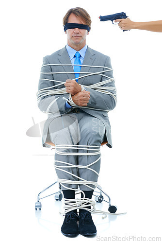 Image of Businessman, tied up and hostage with gun on chair in kidnapped, robbery or silence on a white studio background. Young man or employee with ropes or handcuffs in crime, theft or corruption on mockup