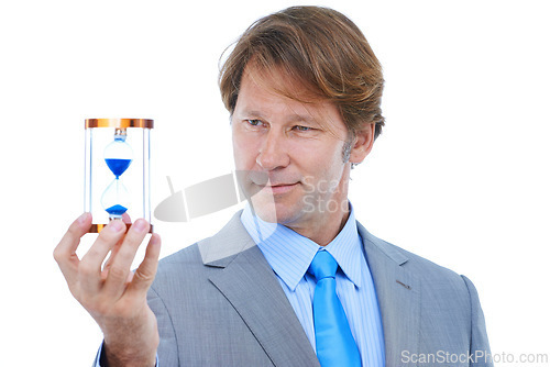 Image of Businessman, checking and time management with hour glass for schedule or limit on a white studio background. Young man or employee looking at sand for minutes, seconds or deadline on mockup space