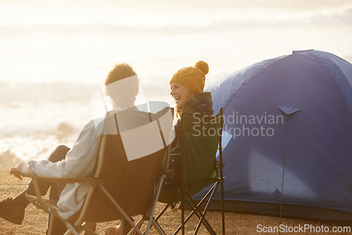 Image of Happy, camping and couple by tent on vacation, adventure or holiday in nature for travel. Smile, love and young man and woman talking, bonding and relaxing outdoor for weekend trip by seaside.