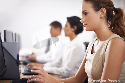 Image of Business woman, computer and typing with team in call center for email, support or online service at office. Female person, consultant or employee working on desktop PC with group or agency for help