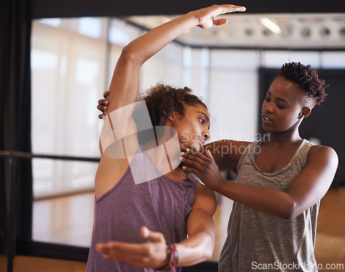 Image of Dancer, instructor and balance for learning, exercise and fitness in a dance studio with form help. Support, teacher and performance workout of man with ballet and wellness in a performing arts class