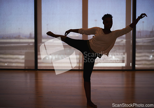 Image of Woman, dancer and stretching with body for fitness, workout or indoor exercise at studio. Female person or ballet in practice, training or balance with foot on floor for graceful dancing or wellness