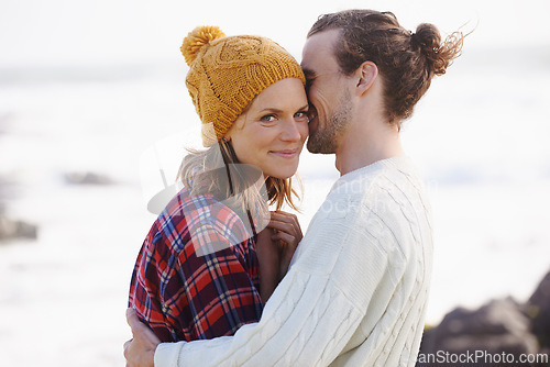 Image of Love, smile and couple on beach in summer together for holiday, romance or vacation on island coast. Nature, travel or getaway with happy young man and woman hugging by ocean or sea for bonding