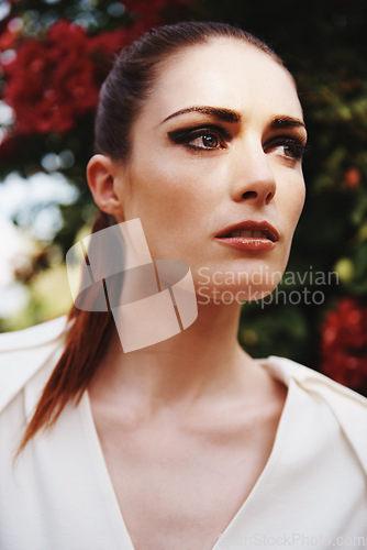 Image of Woman, face and makeup for fashion outdoor with elegant clothes, dramatic style and cosmetics with confidence. Person, eyeshadow and thinking in nature with modern outfit, model aesthetic and pride