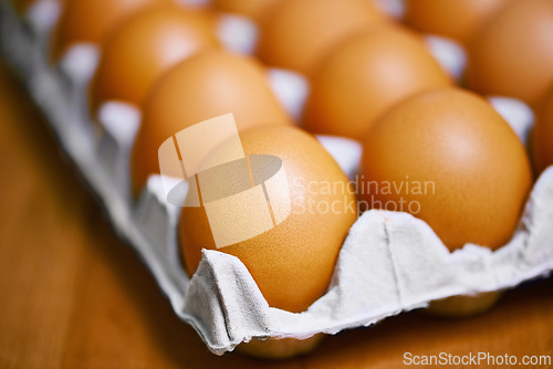 Image of Agriculture, nutrition and eggs in carton for sustainable, organic food and reproduction with wellness. Diet, closeup and produce from livestock for protein, breakfast or healthy meal on table