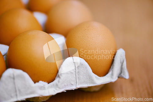 Image of Agriculture, protein and eggs in carton for sustainable, organic food and reproduction with wellness. Diet, closeup and produce from livestock for nutrition, breakfast or healthy meal on table