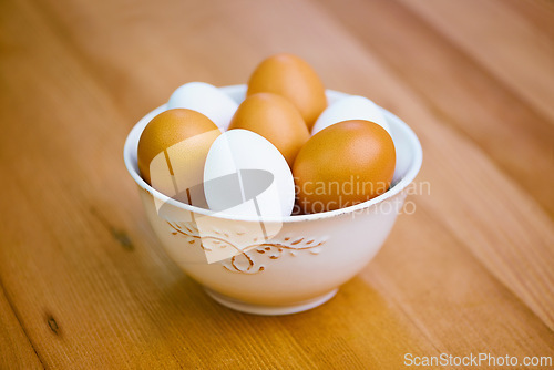 Image of Agriculture, food and eggs in bowl for sustainability, organic produce and reproduction with wellness. Diet, closeup and protein from livestock for nutrition, breakfast or healthy meal on table