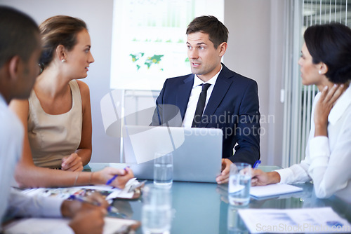 Image of Coworker, office and meeting with laptop for discussion on contract, paperwork and teamwork or collaboration. Business people, boardroom and boss in table with strategy, feedback and company growth.