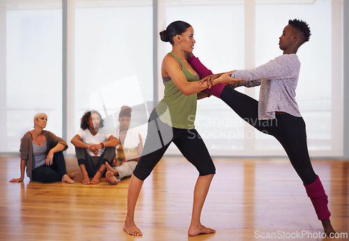 Image of Stretching, women and dance in gym with partner, personal trainer and African friends together at fitness class. Rhythm, moving and people in studio for practice, performance and flexibility of legs