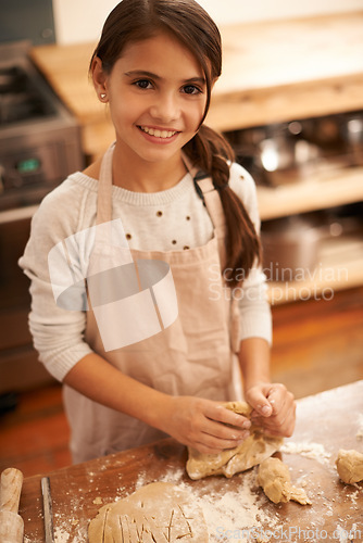 Image of Girl, dough and baking portrait in kitchen, pastry and prepare flour mixture for cooking. Female person, kid and smile for learning in home, child development and education for cookie skill or cake