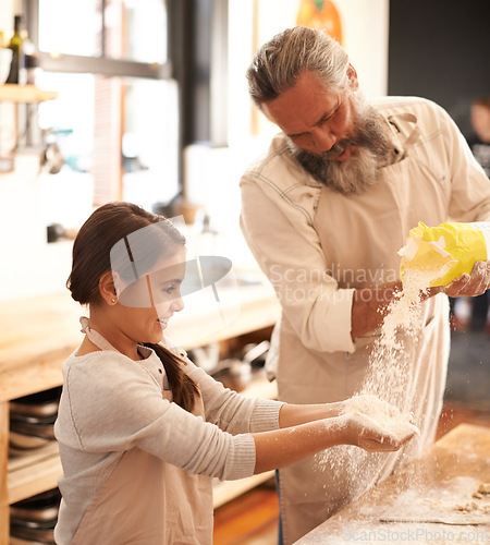 Image of Girl, kid or grandfather with flour in kitchen for cooking, baking or teaching with support or helping. Family, senior man or grandchild with dough or cake preparation in home for bonding or learning