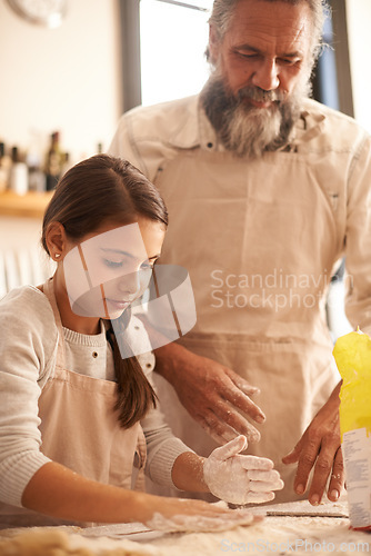 Image of Girl, child and grandpa with dough in kitchen for cooking, baking and teaching with support and helping. Family, senior man and grandchild with flour for preparation in home with bonding and learning