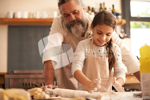 Image of Girl, child and grandfather with dough in kitchen for cooking, baking and teaching with support or helping. Family, senior man and grandchild with cookies preparation in home for bonding and learning