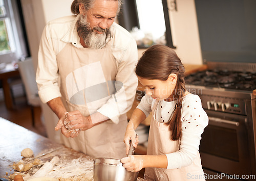 Image of Girl, child and grandfather with baking in kitchen for cooking, cookies and teaching with support and helping. Family, senior man and grandchild with mixing bowl and preparation in home with learning