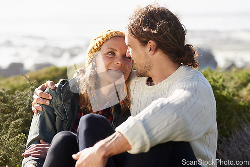 Image of Hug, beach and couple with love, marriage and happiness with weekend break or vacation for honeymoon. Outdoor, romance or embrace with woman or man with sunshine or summer with relationship or smile