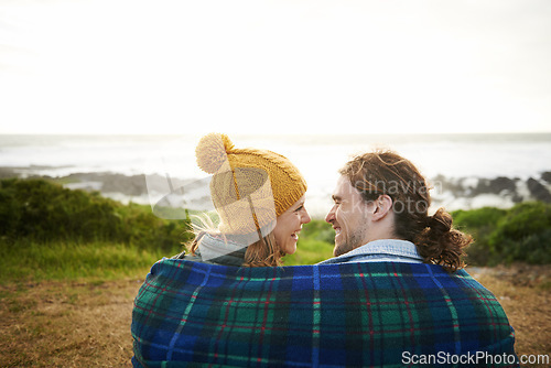 Image of Happy couple, talking or bonding together in nature, blanket or romantic getaway with camping by ocean. Man, woman or love on vacation on weekend break, cape town or travel adventure by sea in sunset