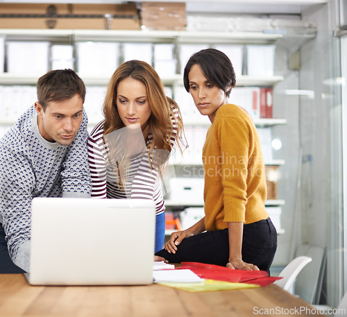 Image of Collaboration, laptop and support in design agency for creative project, planning or review in workplace. Teamwork, technology and diverse group of people for discussion, feedback or strategy