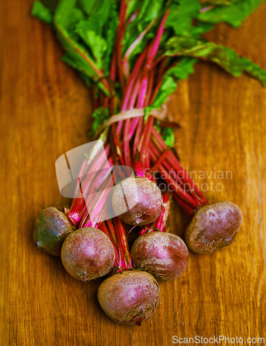 Image of Beetroot, closeup and counter for health, wellness or organic diet on wood countertop. Vegetable, nutrition or produce for eating, gourmet and meal or cuisine with minerals or fibre for weight loss