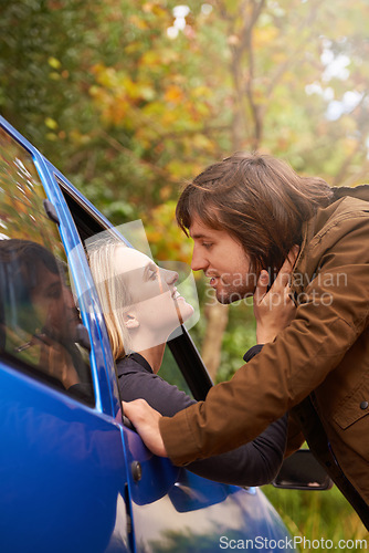 Image of Transport, travel and couple in car for goodbye, greeting and love for journey, leaving and commute. Road trip, driving and man and woman in vehicle window for bonding, relationship and embrace