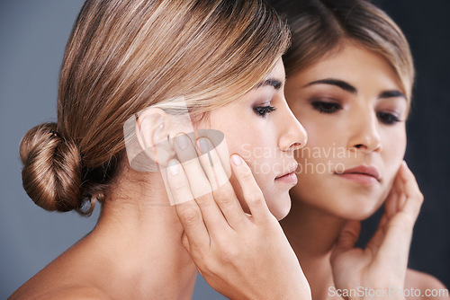 Image of Beauty, facial and mirror with natural woman in studio isolated on blue background for wellness. Aesthetic, face and skincare with reflection of confident young model at spa for cosmetic dermatology