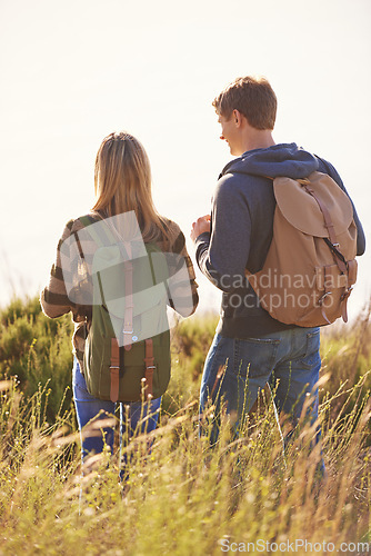 Image of Spring, backpack and couple in nature, adventure and bonding for holiday, vacation and trip to Amsterdam. Outdoor, man and woman together for love in field for hiking of girl and male person