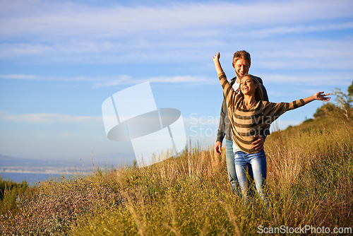 Image of Spring, freedom and couple in nature, happy and bonding for holiday, vacation and trip to Amsterdam. Outdoor, man and woman together for love in field for anniversary of girl and male person