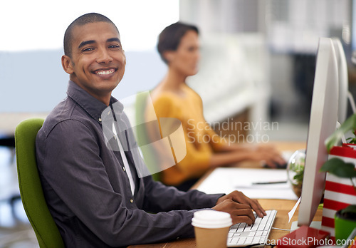 Image of Portrait, smile and computer for happy employee, office and typing at desk in workspace. Technology, keyboard and businessman or journalist person, writing and working for company project online
