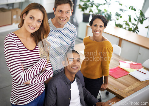 Image of Startup, creative and portrait of employees at desk, teamwork and digital branding or design on laptop or computer. Happy, people and casual for designer company or agency, collaboration and top view