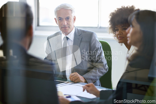 Image of Business people, collaboration and meeting with documents in office for corporate planning, networking and diversity. Professional, employees and teamwork in boardroom with lens flare and cooperation