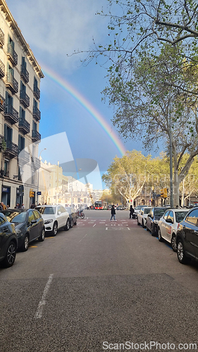 Image of BARCELONA, SPAIN - APRILL 1, 2024: Rainbow over city street