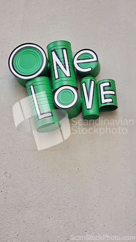 Image of Green one love sign on building