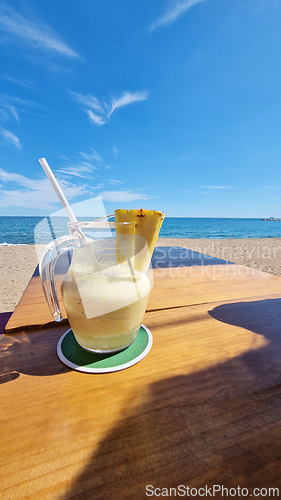 Image of Drink on wooden table by the ocean