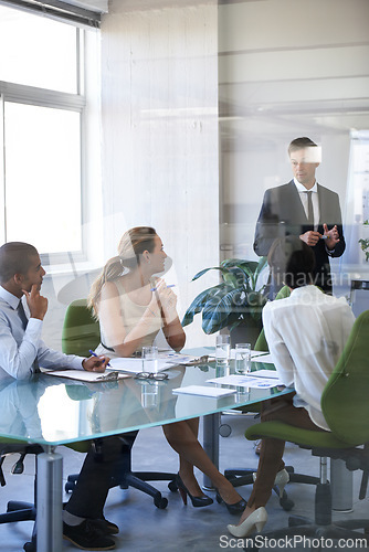 Image of Meeting, presentation and businessman in office with window, report or speaker at b2b workshop. Teamwork, discussion and business people in conference room brainstorming ideas, planning and review