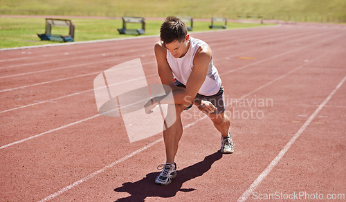 Image of Fitness, running and stretching with athlete man getting ready on track for sports, race or competition. Exercise, training and warm up with confident young person at stadium or venue for event