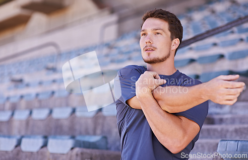 Image of Sports, arms and man stretching in stadium for race, marathon or competition training for health. Fitness, energy and male runner athlete with warm up exercise for running cardio workout on track.