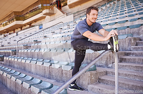 Image of Fitness, legs and man stretching in stadium for race, marathon or competition training for health. Sports, energy and male runner athlete with warm up exercise for running cardio workout on track.